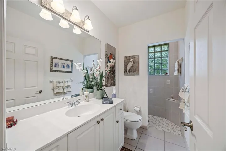 Bathroom with vanity, tile patterned floors, and a walk in shower
