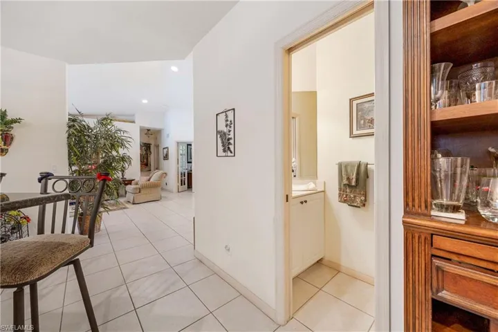 Corridor with light tile patterned floors and recessed lighting