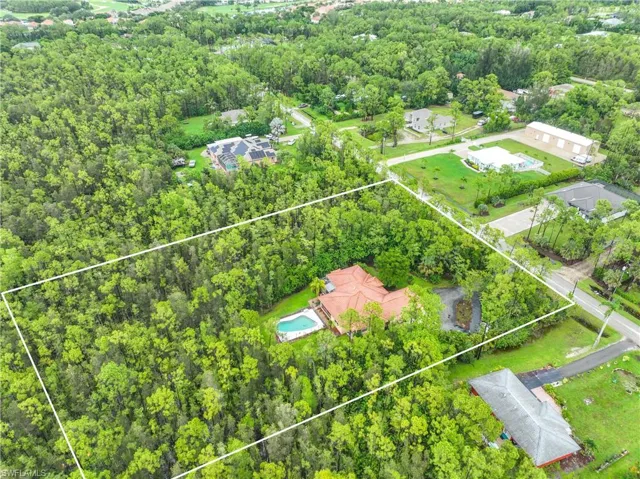 Aerial view of property and surrounding area featuring property parcel outlined