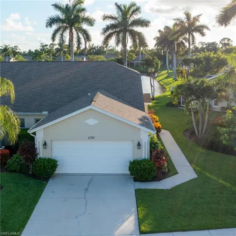 Aerial view featuring a wide side yard, 2 car garage and southwestern gorgeous  long-water view