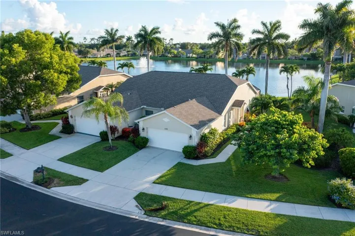 Aerial view featuring a wide side yard, 2 car garage and southwestern gorgeous long-water view