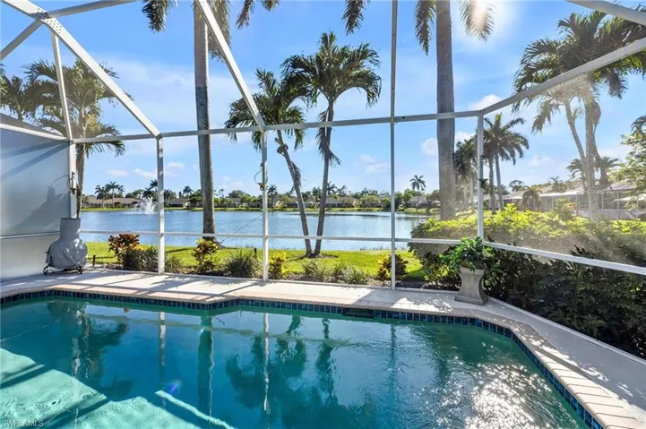View of swimming pool with a screened lanai and southwestern long-water views!