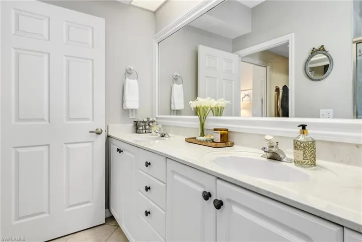 Bathroom featuring dual vanity sinks and tile floors - fresh paint