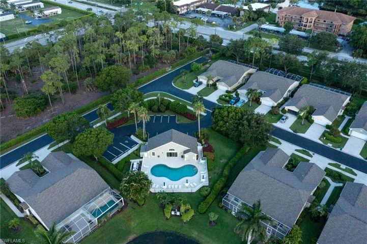 Drone / aerial view of clubhouse pool and parking