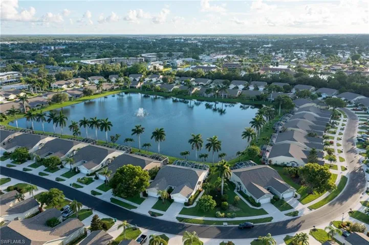 Birds eye view of property with a wide side yard and a water view