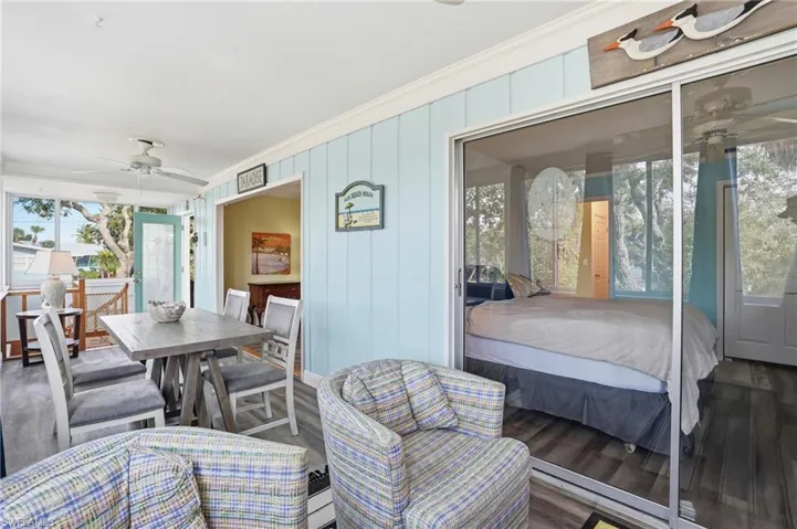 Bedroom with crown molding, wood finished floors, and a ceiling fan - Virtually Edited Image