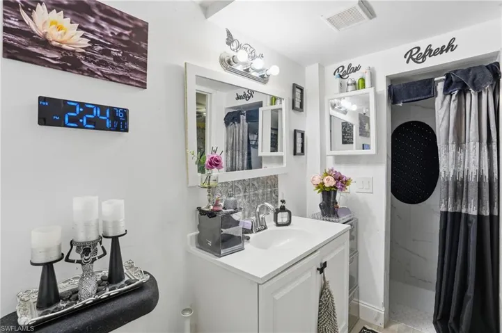 Full bathroom featuring a stall shower and vanity - Virtually Edited Image