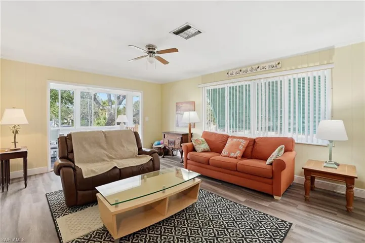 Living room featuring light wood-type flooring and ceiling fan