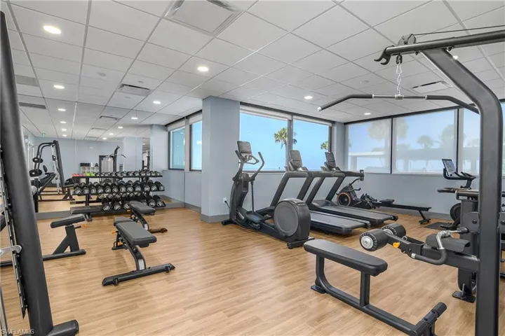 Workout area featuring a paneled ceiling and recessed lighting