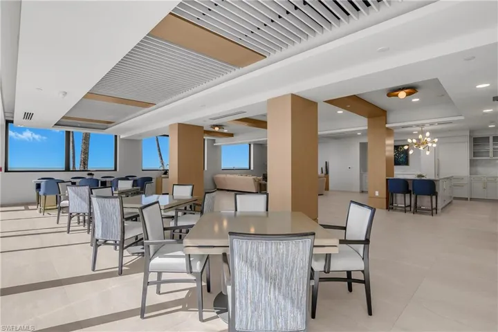 Community room with Gulf views and a chandelier and light tile patterned floors