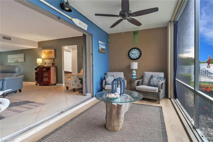 Living area with a ceiling fan, a textured ceiling, baseboard heating, and light tile patterned flooring
