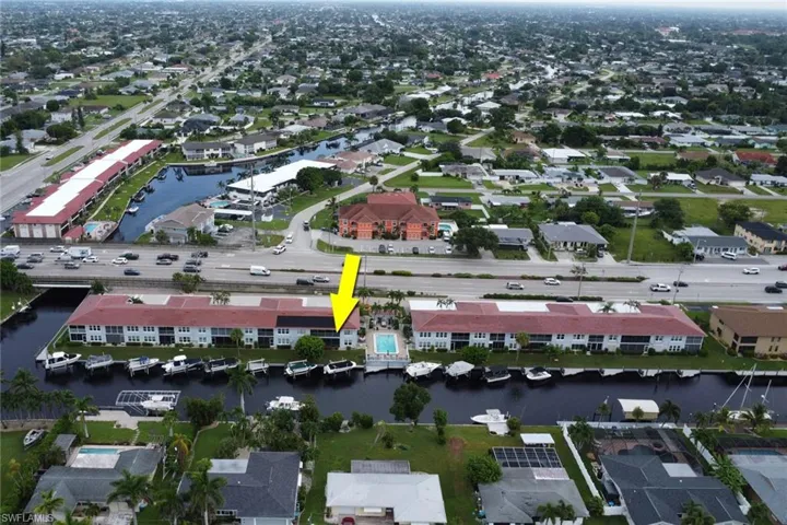 Aerial view of property's location with nearby suburban area