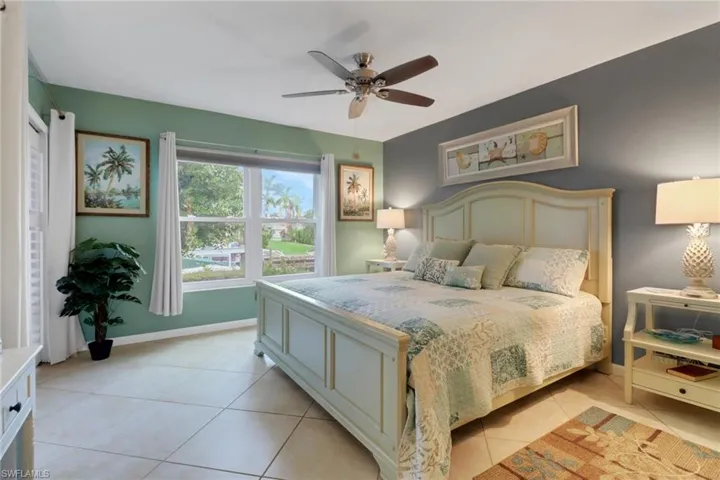 Bedroom featuring light tile patterned floors and a ceiling fan