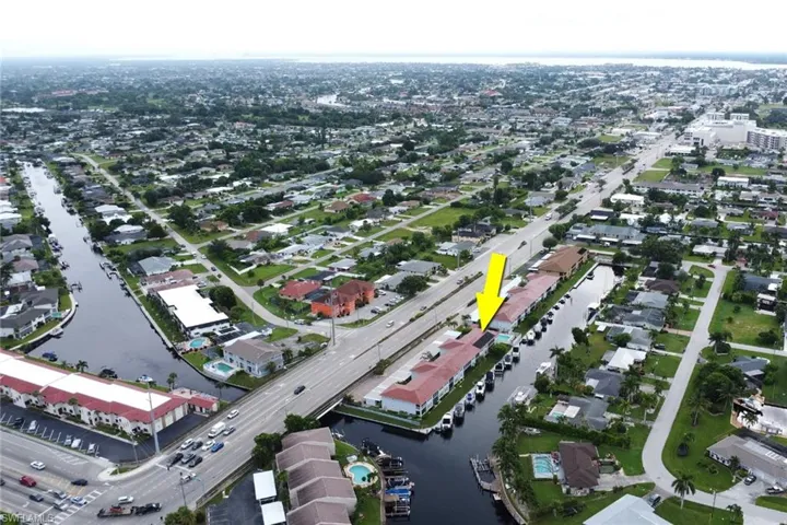 Aerial overview of property's location with a large body of water and nearby suburban area