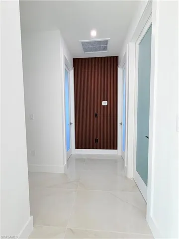 Hallway featuring baseboards and recessed lighting