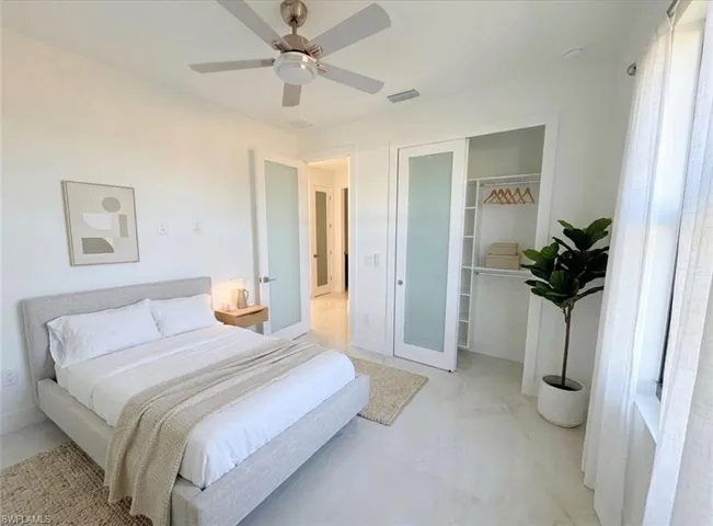 Bedroom with ceiling fan and a closet