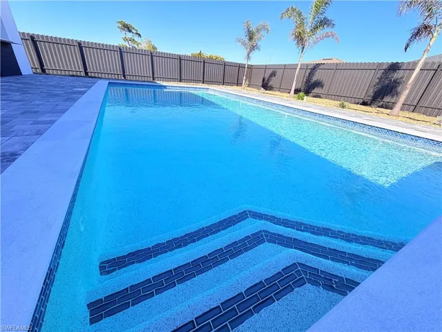 View of swimming pool with a fenced backyard