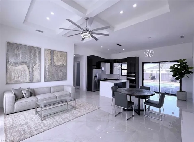 Living room featuring coffered ceiling, recessed lighting, and a ceiling fan
