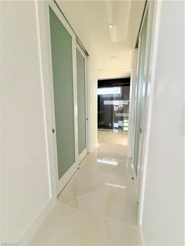 Hall featuring light tile patterned flooring