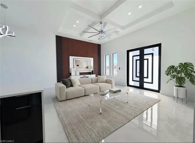 Living room with coffered ceiling, a ceiling fan, recessed lighting, and light marble finish floors