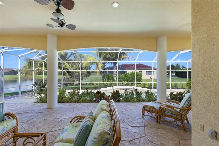 View of patio / terrace with a sunroom, ceiling fan, and a lanai
