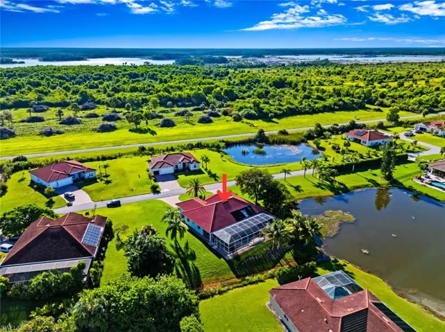 Aerial perspective of suburban area featuring a nearby body of water