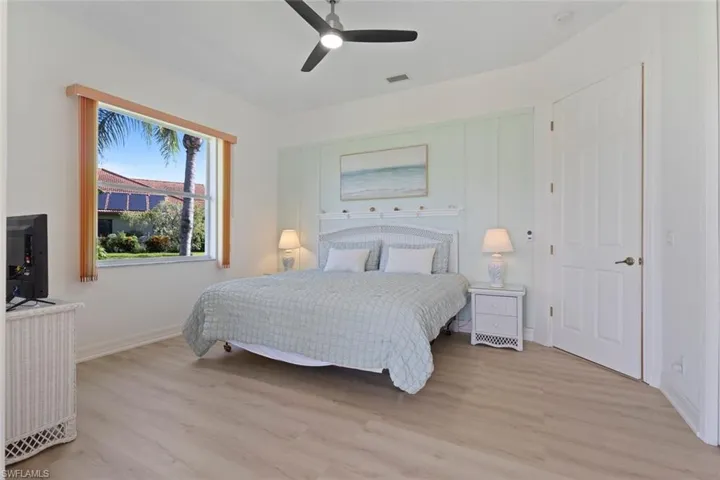 Bedroom with light wood-style flooring and a ceiling fan