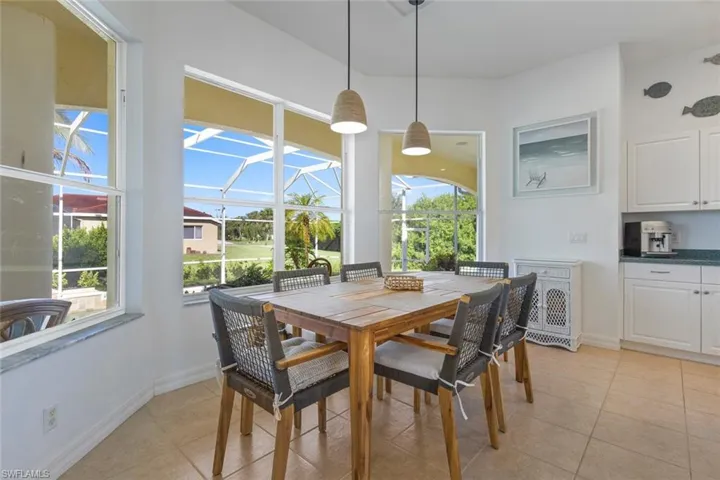 Dining room featuring a sunroom and light tile patterned floors