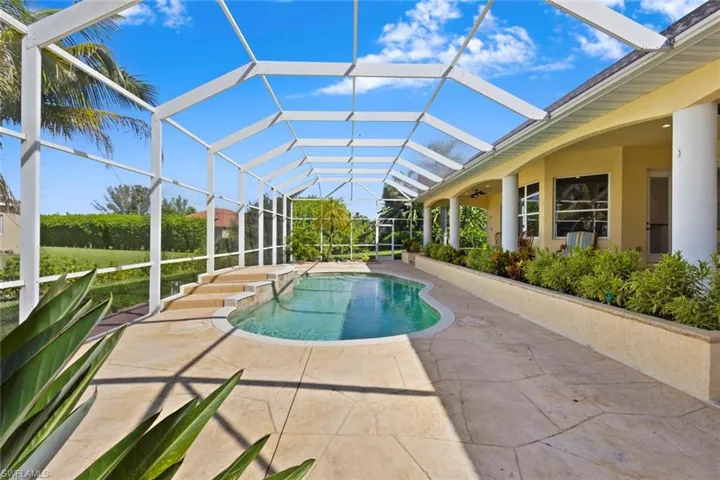Outdoor pool featuring a sunroom, a patio area, a lanai, and a jacuzzi