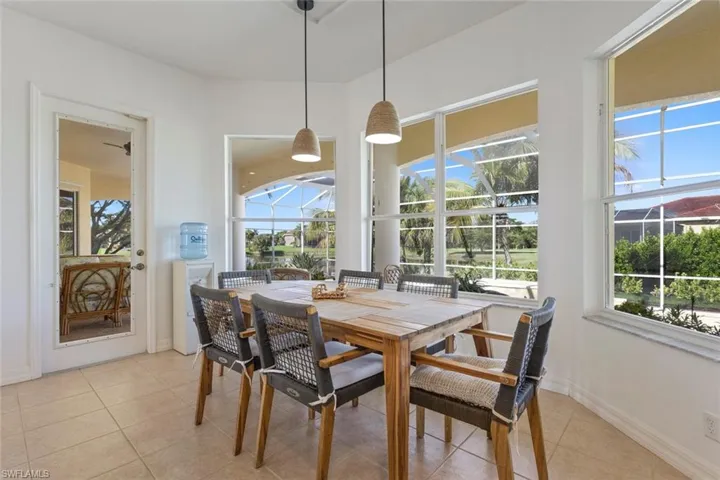 Dining room featuring a sunroom, light tile patterned floors, and plenty of natural light