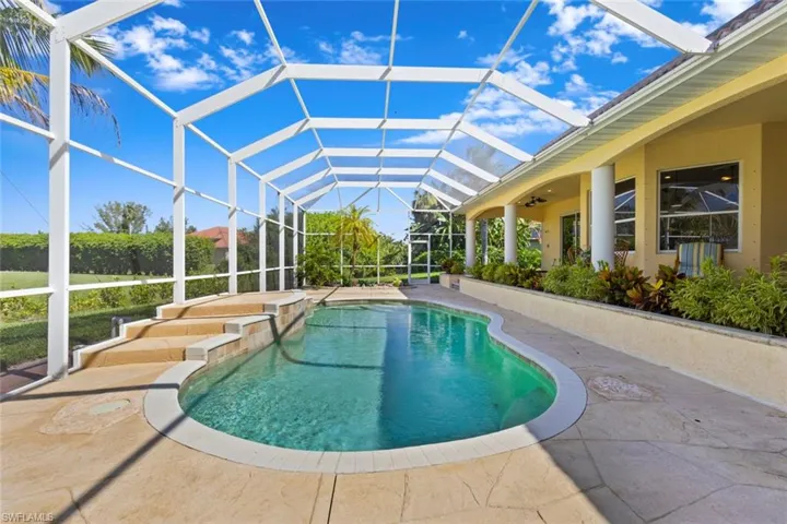 Swimming pool with a sunroom, a patio, and glass enclosure