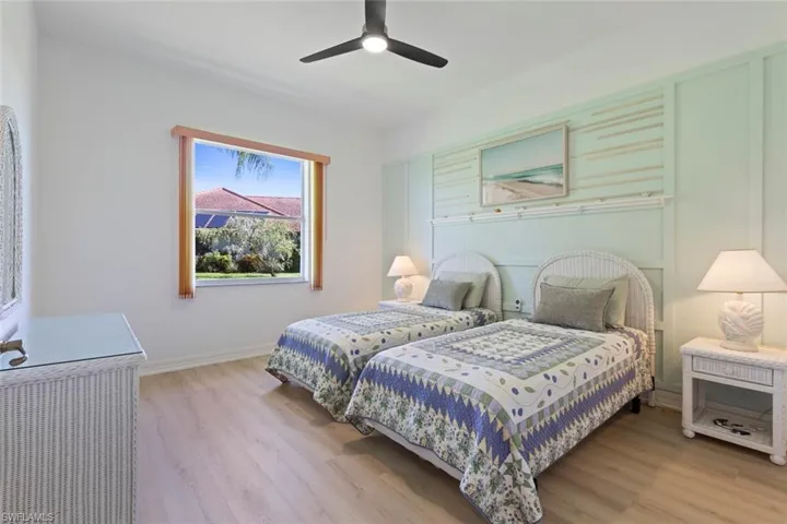 Bedroom with light wood finished floors and a ceiling fan