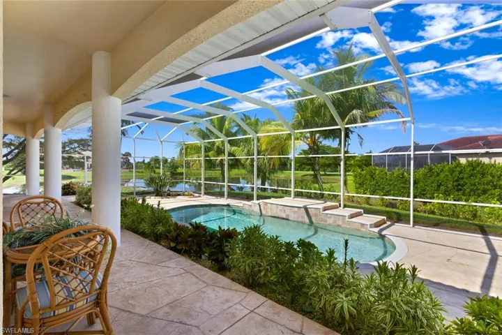 Swimming pool featuring a sunroom, a patio, a lanai, and a hot tub