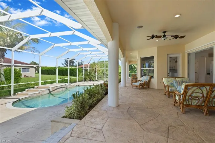 Outdoor pool with a patio area, a ceiling fan, a sunroom, a jacuzzi, and a lanai