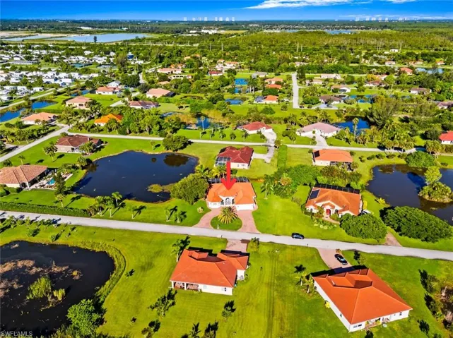 Aerial perspective of suburban area featuring a nearby body of water