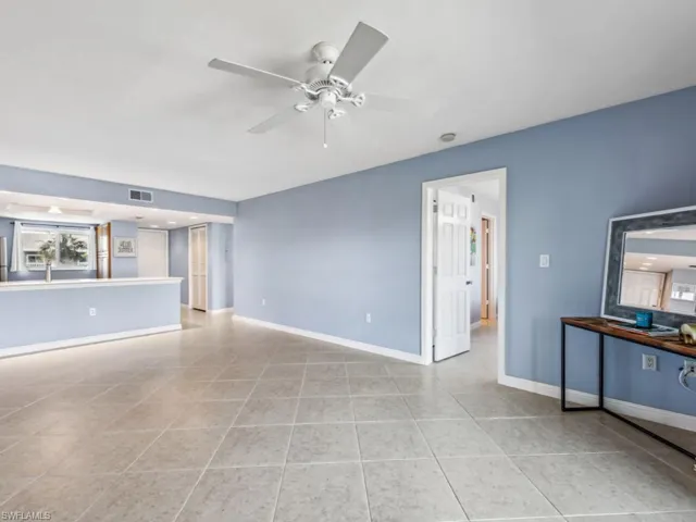 Unfurnished living room featuring light tile patterned floors and ceiling fan