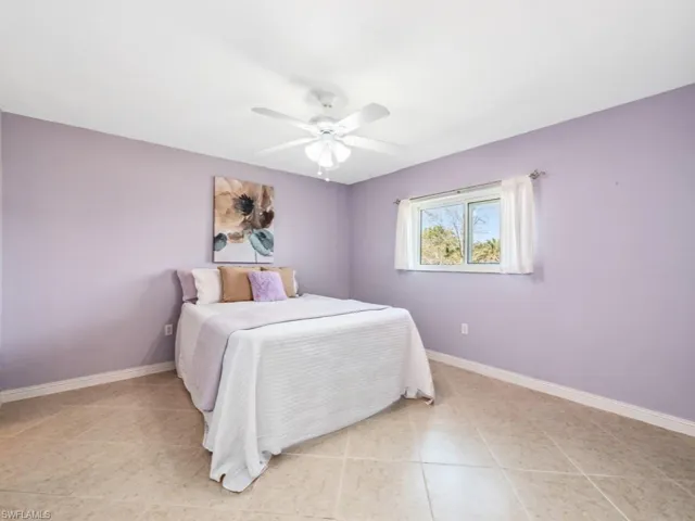 Tiled bedroom with ceiling fan
