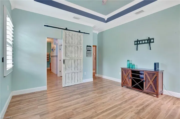 Primary Bedroom with barn door leading to Gorgeous ensuite Bathroom