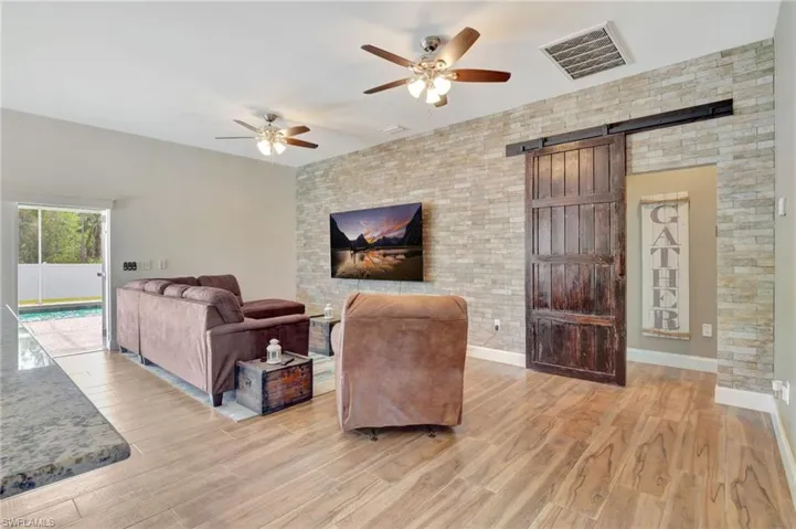 Spacious Great room with Mounted TV and access to outdoor area and heated Pool