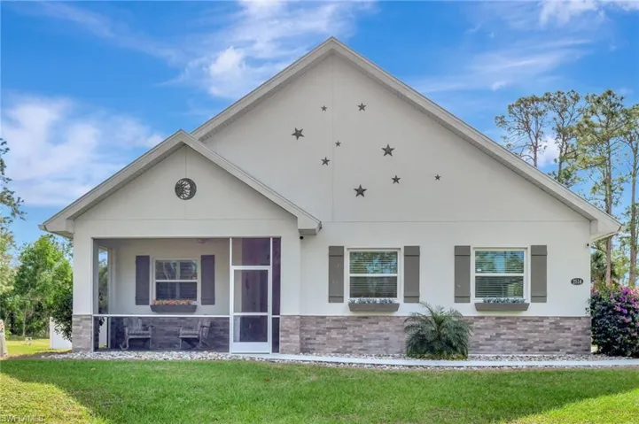 View of front of house featuring a front yard and a sunroom