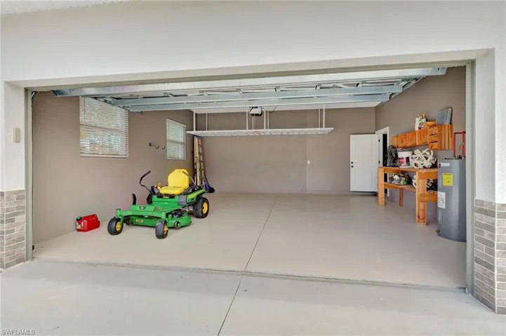 Garage with a garage door opener and built in work area.