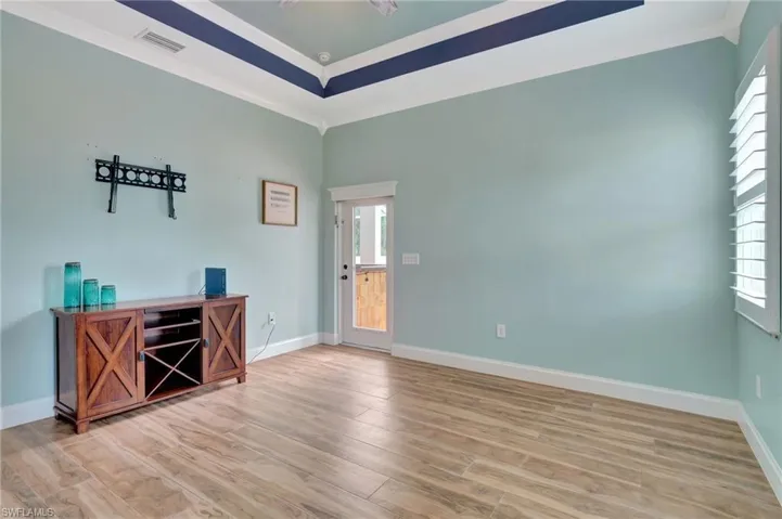 Primary bedroom with ornamental molding