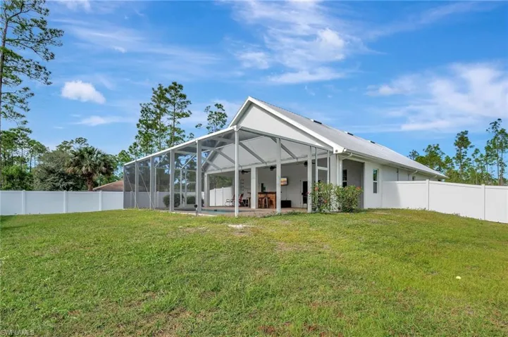 Back of home with screened lanai and heated Pool