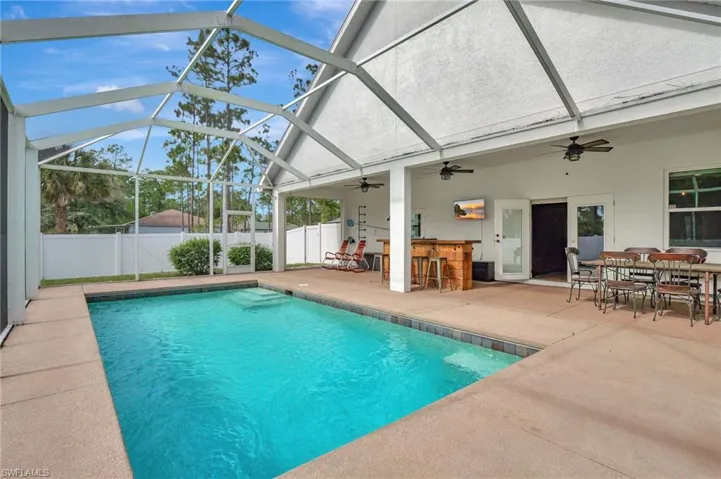 Heated swimming pool with outdoor bar and large sundeck area