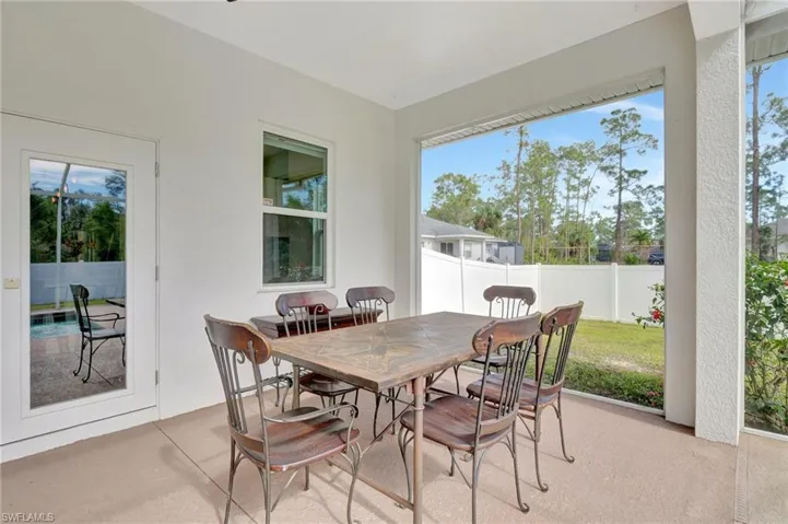 Screened in Lanai with dining table, chairs and buit in bar