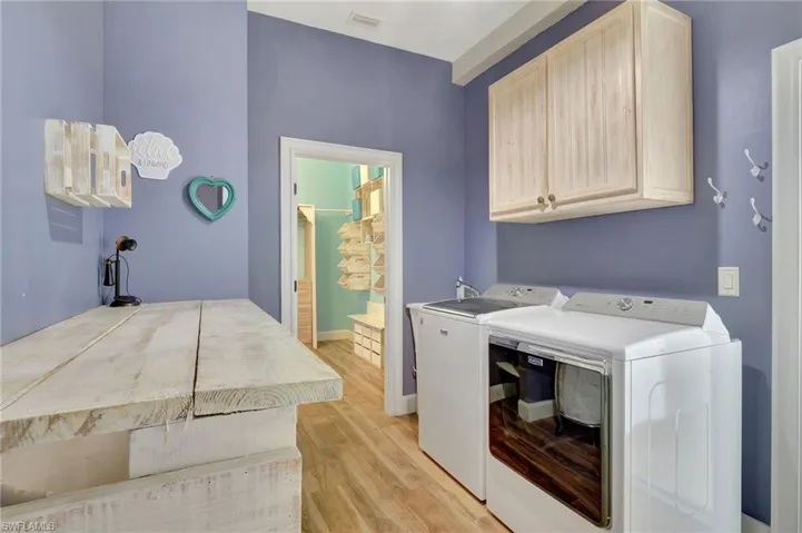 Laundry room with washer and dryer, countertop and cabinets