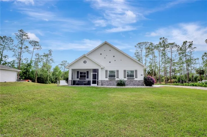 View of front of home featuring a Screened in front porch and front lawn