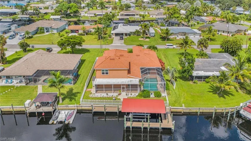 Aerial perspective of suburban area with a nearby body of water