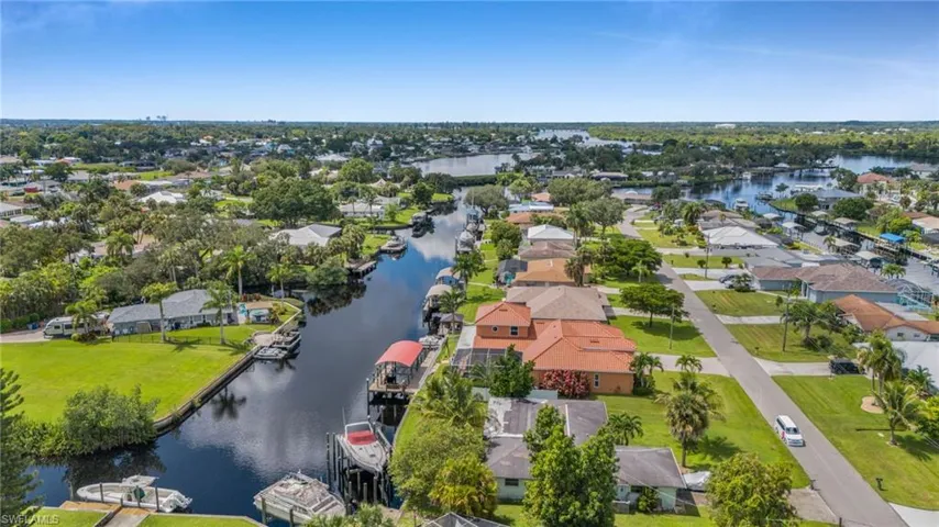 Aerial view of residential area featuring a nearby body of water