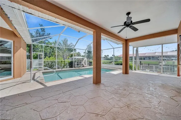 Outdoor pool with a patio area, a lanai, a sunroom, and ceiling fan